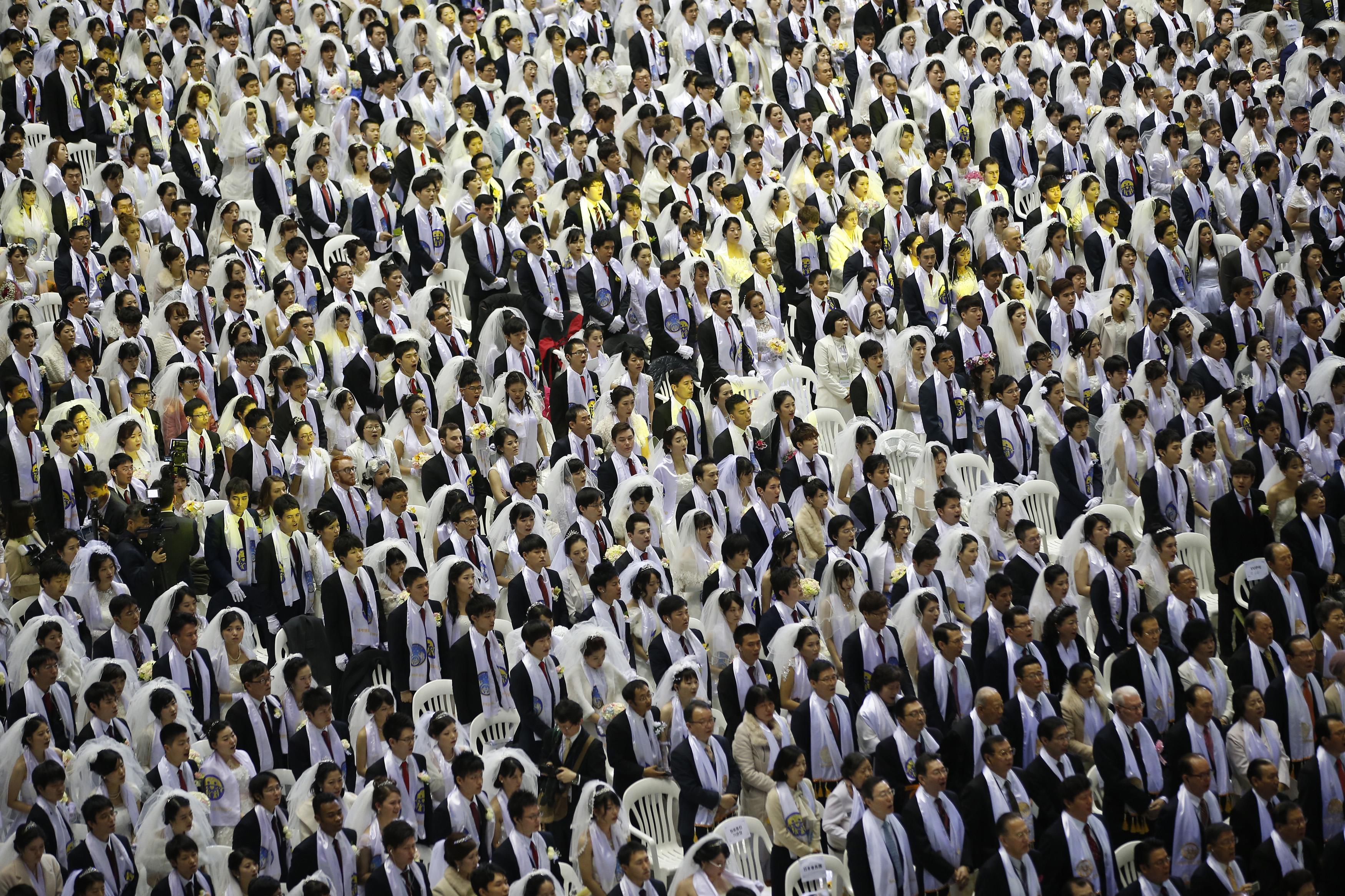 Newlyweds attend a mass wedding ceremony of the Unification Church at Cheongshim Peace World Centre in Gapyeong