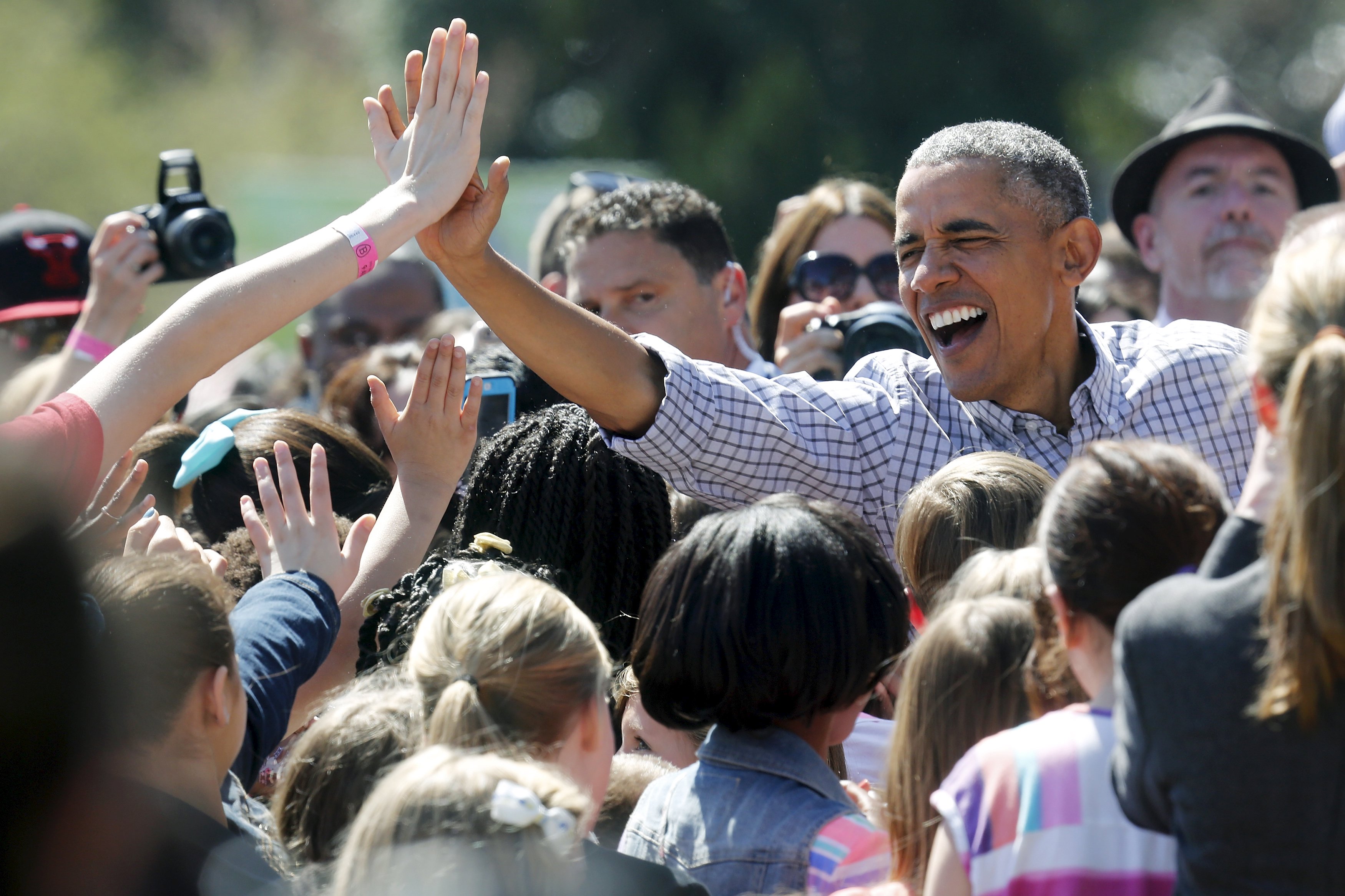 Obama high-fives with children after reading the storybook