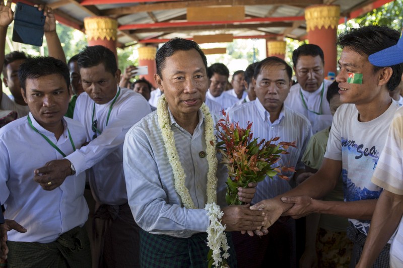 Shwe Mann, speaker of lower house of parliament, shakes hands with a supporter as he campaigns in his constituency in Phyu