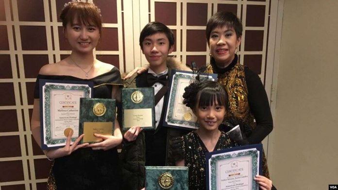 Sienny Debora (kanan belakang) bersama ketiga murid pianonya (Foto VOA, Naratama).