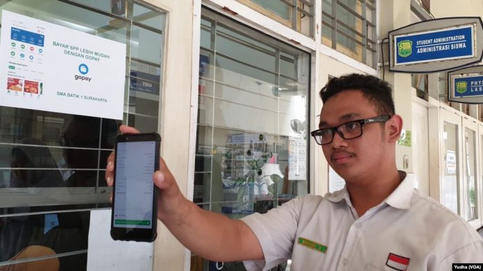 Pembayaran SPP melalui aplikasi GoPay di SMA Batik 1 Solo, Selasa (18 Feb). (Foto VOA Yudha Satriawan)
